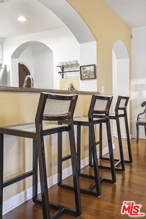 bar featuring dark wood-type flooring