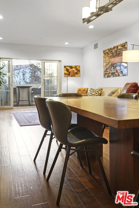 dining space with plenty of natural light and dark hardwood / wood-style floors