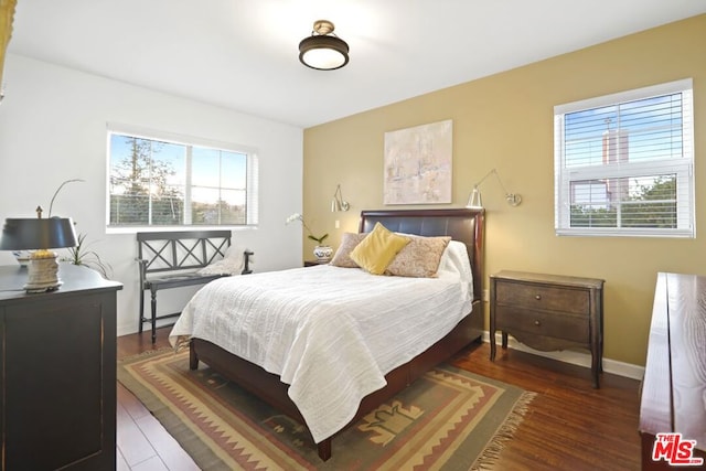 bedroom with dark hardwood / wood-style flooring