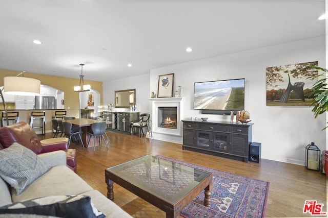 living room featuring a notable chandelier and wood-type flooring