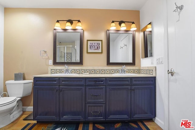 bathroom featuring vanity, walk in shower, and toilet