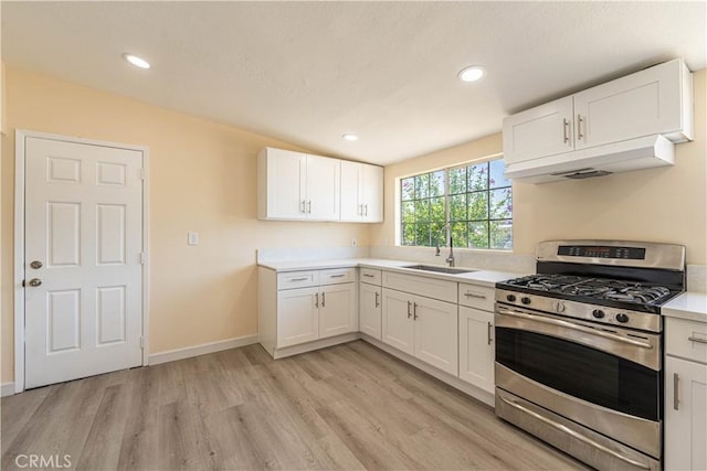 kitchen with white cabinetry, stainless steel range with gas cooktop, and sink