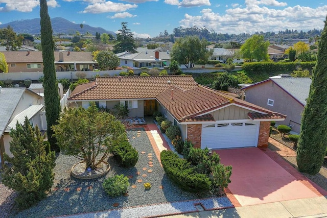 view of front facade featuring a mountain view and a garage