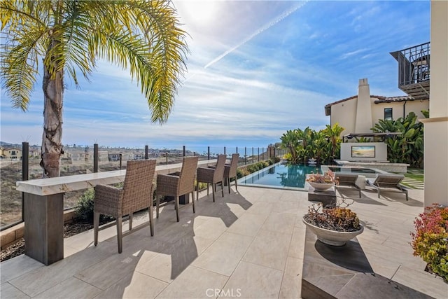 view of patio with a swimming pool with hot tub