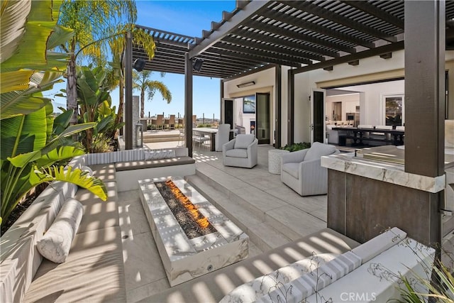 view of patio / terrace with a pergola and an outdoor living space with a fire pit