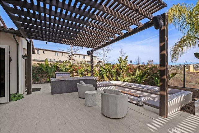 view of patio with an outdoor living space with a fire pit and a pergola