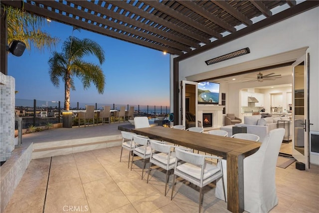 view of patio / terrace featuring an outdoor fireplace, a pergola, and an outdoor bar