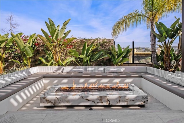 view of swimming pool with an outdoor living space with a fire pit