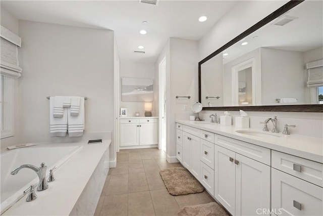 bathroom featuring vanity, a bathtub, and tile patterned flooring