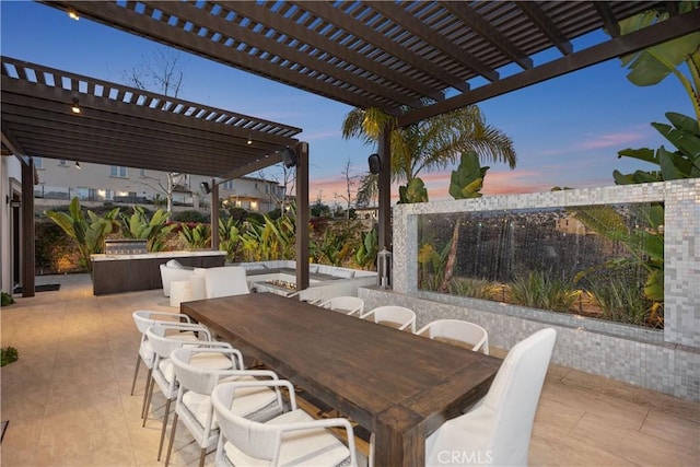 patio terrace at dusk featuring a pergola and an outdoor bar