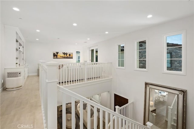 hallway with light hardwood / wood-style floors