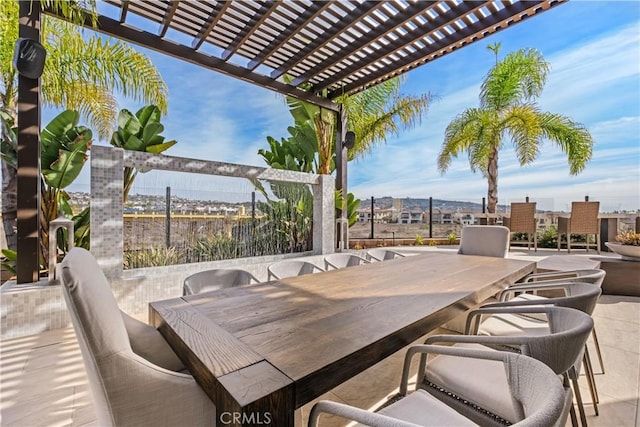 view of patio featuring a bar and a pergola