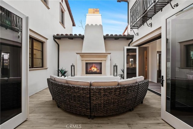 view of patio featuring an outdoor living space with a fireplace