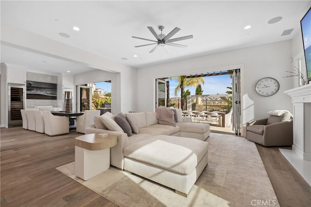 living room featuring hardwood / wood-style flooring and ceiling fan