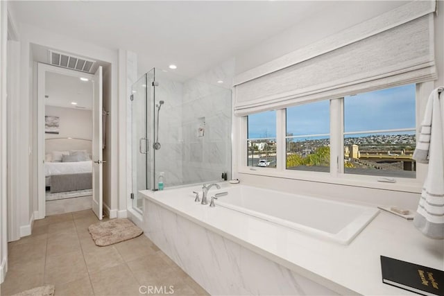 bathroom featuring tile patterned floors and independent shower and bath