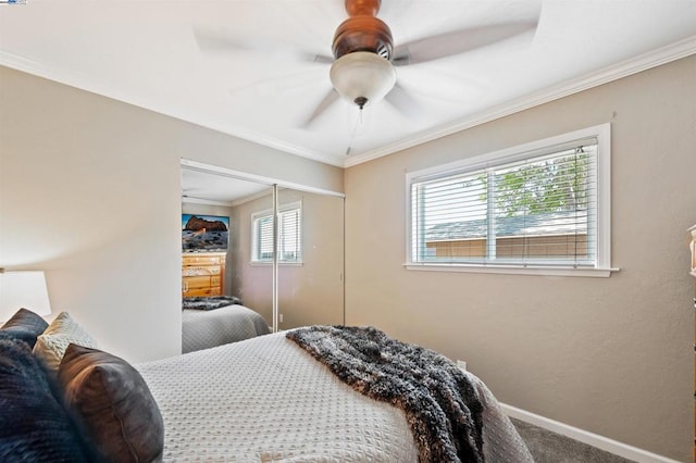 bedroom featuring carpet floors, ornamental molding, a closet, and ceiling fan