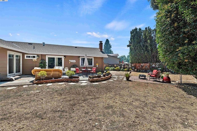 rear view of property featuring an outdoor hangout area and a patio area