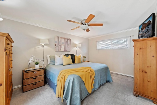 carpeted bedroom featuring crown molding and ceiling fan