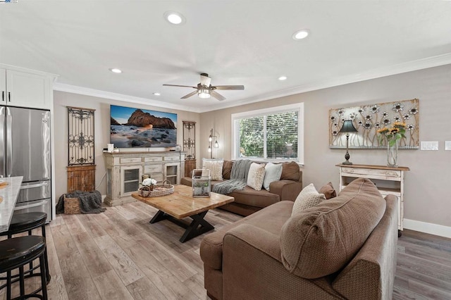 living room featuring ornamental molding, hardwood / wood-style floors, and ceiling fan