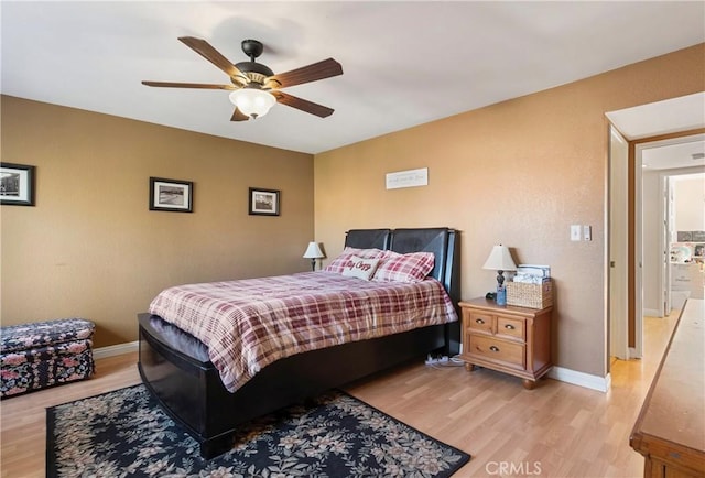 bedroom with ceiling fan and light hardwood / wood-style floors