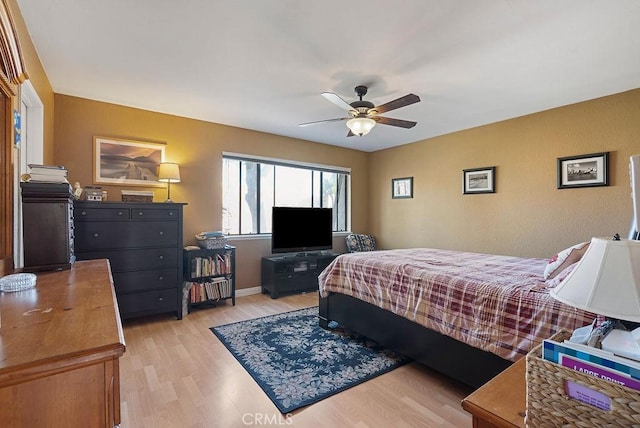 bedroom with ceiling fan and light hardwood / wood-style flooring