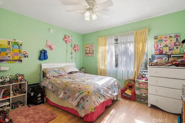 bedroom with ceiling fan and light hardwood / wood-style floors