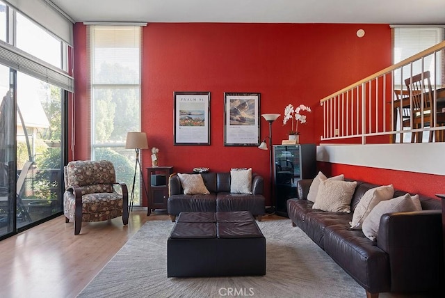 living room with expansive windows and hardwood / wood-style flooring