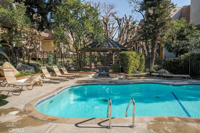 view of swimming pool with a gazebo and a patio area