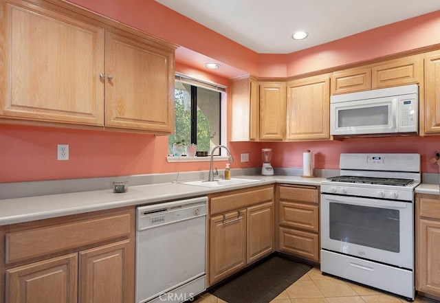 kitchen with light tile patterned flooring, sink, and white appliances