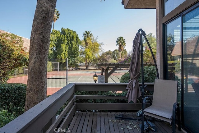 wooden deck featuring tennis court