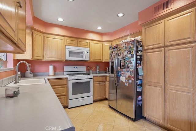 kitchen with sink, light brown cabinets, white appliances, and light tile patterned floors