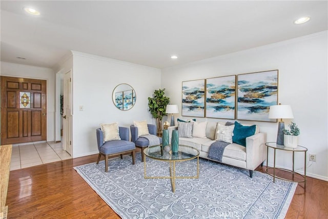 living room with ornamental molding and light hardwood / wood-style floors