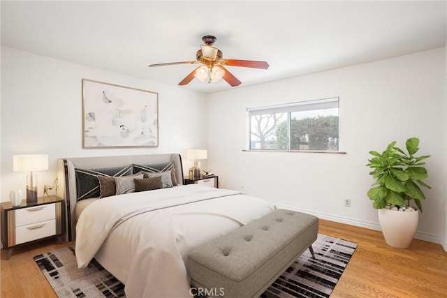 bedroom with light hardwood / wood-style flooring and ceiling fan