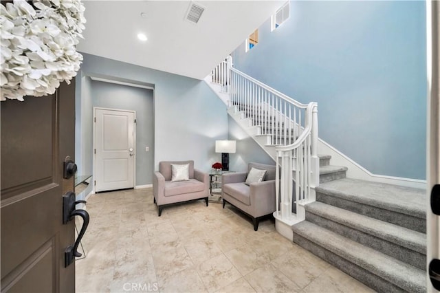 foyer featuring stairs, recessed lighting, baseboards, and visible vents