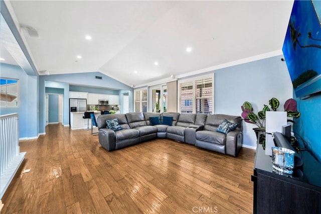 living room with light hardwood / wood-style flooring and vaulted ceiling