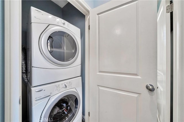 washroom featuring laundry area and stacked washer and dryer