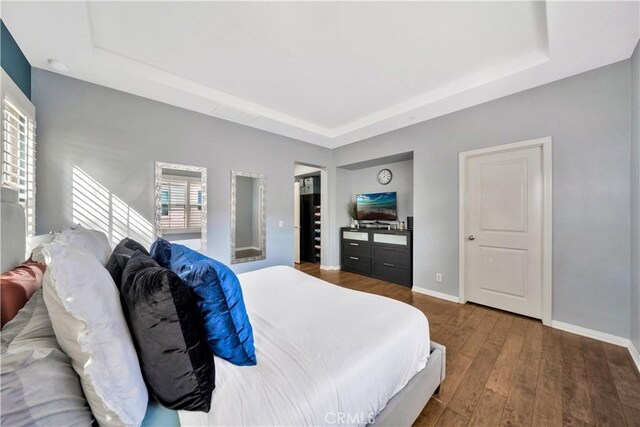 60 Peony, Irvine, CA 92618 - bedroom with a tray ceiling, baseboards, and wood finished floors