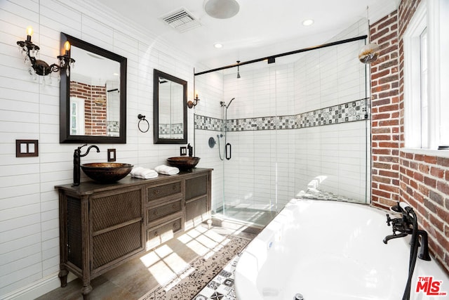 bathroom featuring shower with separate bathtub, tile walls, and vanity