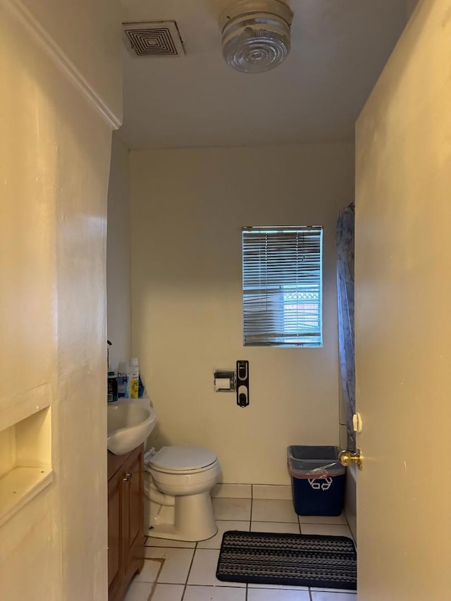 bathroom with tile patterned floors, vanity, and toilet