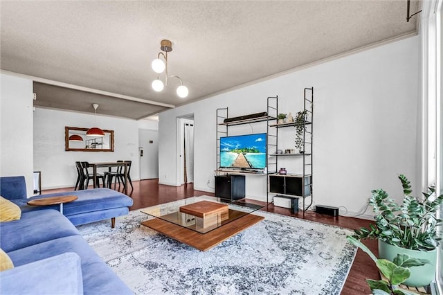 living room featuring dark wood-type flooring, an inviting chandelier, and a textured ceiling