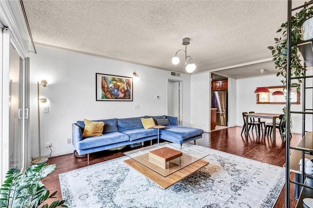 living room with dark hardwood / wood-style flooring and a textured ceiling