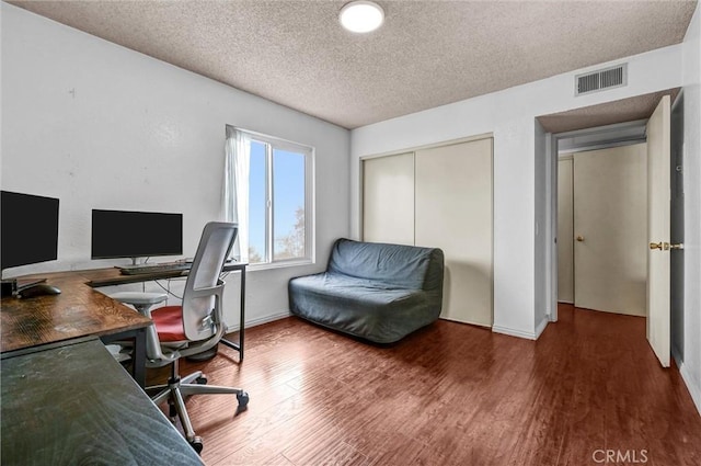 office featuring dark hardwood / wood-style floors and a textured ceiling