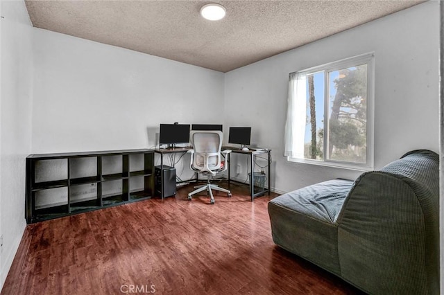 office area with wood-type flooring and a textured ceiling