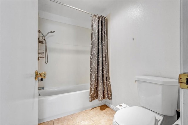 bathroom featuring shower / bathtub combination with curtain, tile patterned floors, and toilet