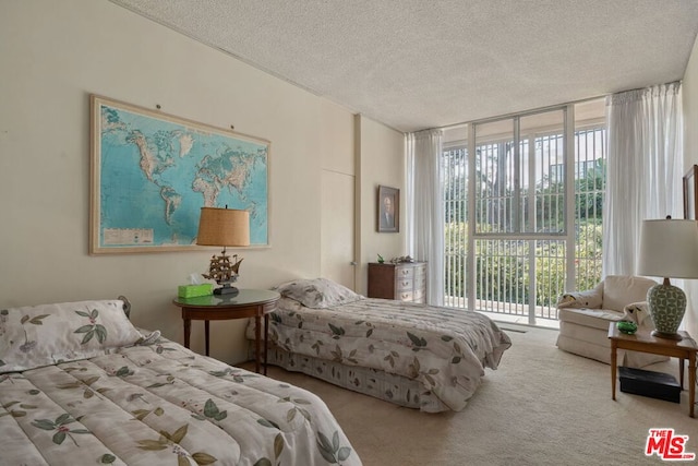 bedroom featuring floor to ceiling windows, access to outside, light carpet, and a textured ceiling