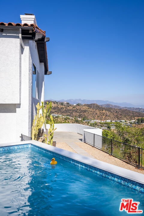 view of pool with a mountain view