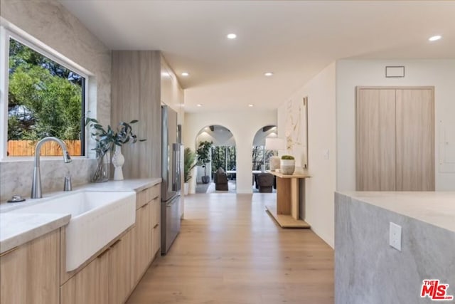 hall featuring sink and light hardwood / wood-style flooring