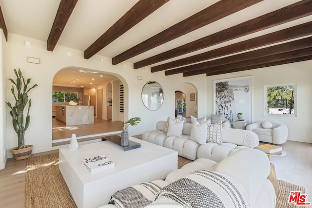 living room featuring beamed ceiling