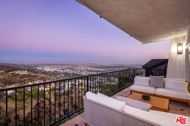 balcony at dusk with an outdoor living space