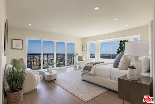 bedroom with hardwood / wood-style flooring and access to outside